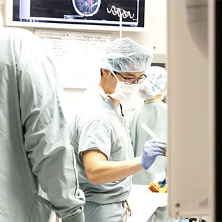 Visiting fellows working together in a hospital room.